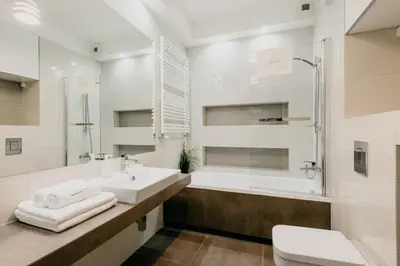 a bathroom with a sink and a tub and a toilet at inQse Krakow Brewery Residence in Kraków