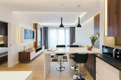 a kitchen with a desk and a living room at inQse Krakow Brewery Residence in Kraków