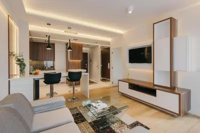 a living room with a couch and a tv at inQse Krakow Brewery Residence in Kraków