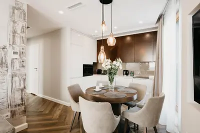 a kitchen and dining room with a table and chairs at inQse Krakow Brewery Residence in Kraków