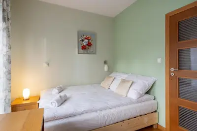 a bedroom with a bed and a bowl of fruit on a table at BIG Prestige Apartment - 6 min Main Square Kraków in Kraków