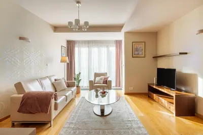 a living room with a couch and a tv at BIG Prestige Apartment - 6 min Main Square Kraków in Kraków