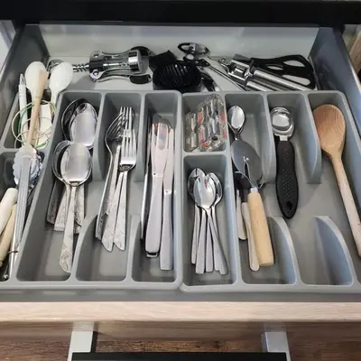 a tray filled with utensils in a drawer at Korczaka Apartments Prokocim in Kraków