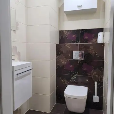 a bathroom with a toilet and a sink at Korczaka Apartments Prokocim in Kraków