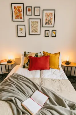 a bedroom with a bed with books on it at Vilao Apartments- Łazarza in Kraków