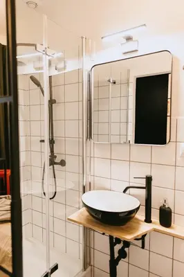 a bathroom with a sink and a shower at Vilao Apartments- Łazarza in Kraków