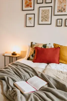 two books sitting on top of a bed at Vilao Apartments- Łazarza in Kraków