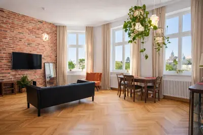 a living room with a couch and a table at InPoint Royal Wawel View & Old Town Apartment Self Check-in in Kraków