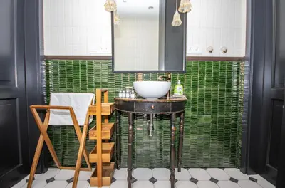 a bathroom with a sink and a green wall at InPoint Royal Wawel View & Old Town Apartment Self Check-in in Kraków