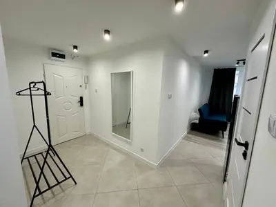 a small bedroom with a bed and a window at Apartament Powstańców 17 in Oświęcim