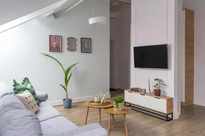 a living room with two tables and a couch at Barbakan Loft Old Town in Kraków