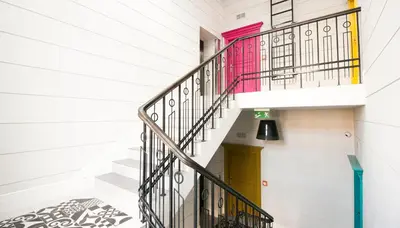 a staircase in a house with a yellow door at Barbakan Loft Old Town in Kraków