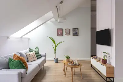 a living room with a couch and a table at Barbakan Loft Old Town in Kraków