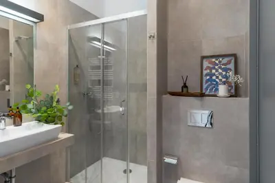 a bathroom with a shower and a sink at Barbakan Loft Old Town in Kraków