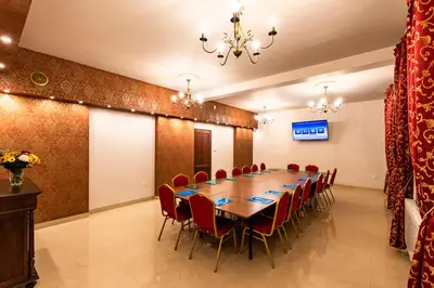 a conference room with a long table and red chairs at Hotel Kasztelan in Dobczyce