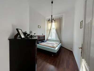 a small room with a bed and a window at Old Town Apartments 2 in Kraków