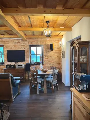 a dining room with a table and a tv at Kefasówka in Zawoja
