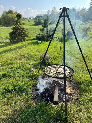 a barbecue in a field with a grill at Kefasówka in Zawoja