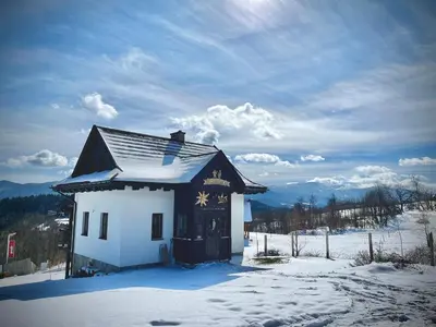 a small house with snow on it in the snow at Kefasówka in Zawoja