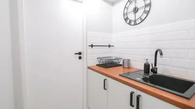 a small room with two beds and a television at Przytulny Zakątek Wawel in Kraków