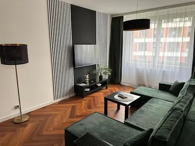 a living room with a couch and a table at Bajeczny Apartament 88 - 20 min to Cracow Airport - beside the Vistula River in Kraków