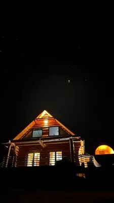 a house with a lit up roof at night at Domek z Bali in Zawoja