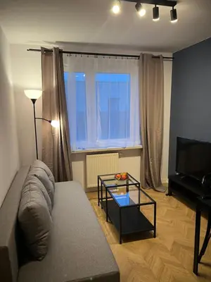 a living room with a couch and a glass table at Raciborska Loft in Kraków