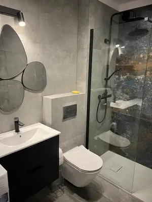 a bathroom with a shower and a toilet and a sink at Raciborska Loft in Kraków