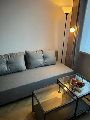a living room with a couch with a glass table at Raciborska Loft in Kraków