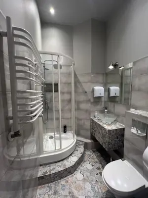 a bathroom with a shower and a toilet and a sink at Fox hostel in Kraków
