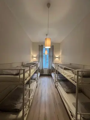 a room with several bunk beds and a window at Fox hostel in Kraków