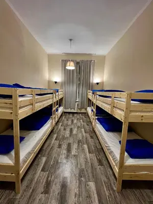 a room with three bunk beds in it at Fox hostel in Kraków
