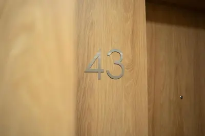 a wooden door with the number on it at K&M Apartments Tauron Arena in Kraków