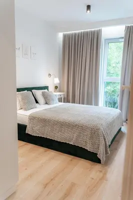a bedroom with a bed and a window at K&M Apartments Tauron Arena in Kraków