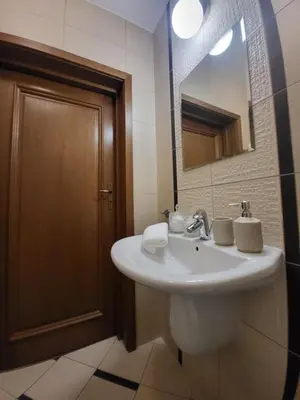 a bathroom with a white sink and a mirror at Kochanowskiego 12 in Kraków
