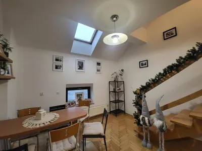 a living room with a dining room table and a skylight at Kochanowskiego 12 in Kraków