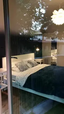 a bedroom with a bed and a window at Art Zwierzyniecka in Kraków
