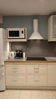 a kitchen with a white refrigerator and a microwave at Art Zwierzyniecka in Kraków