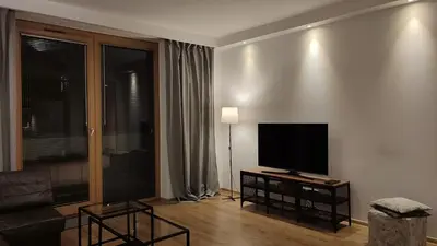 a living room with a flat screen tv on a wall at Art Zwierzyniecka in Kraków