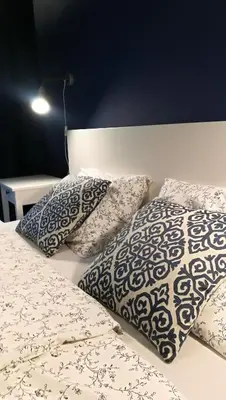 a bed with two pillows on top of it at Art Zwierzyniecka in Kraków