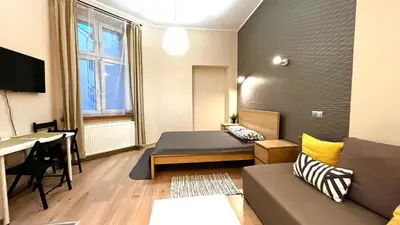 a living room with a couch and a table at Przestronne Studio w centrum in Kraków
