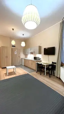 a living room with a table and a television at Przestronne Studio w centrum in Kraków