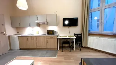 a kitchen with a counter and a table and a tv at Przestronne Studio w centrum in Kraków