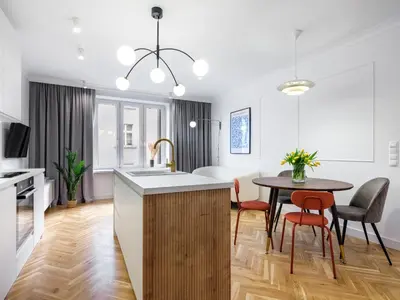 a kitchen and dining room with a sink and a table at Starowiślna by Tyzenhauz in Kraków