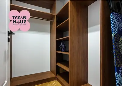 a walk in closet with a wooden door at Starowiślna by Tyzenhauz in Kraków