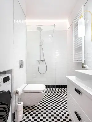 a white bathroom with a black and white checkered floor at Starowiślna by Tyzenhauz in Kraków