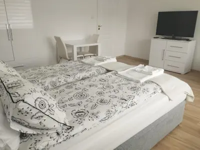 a bedroom with a large bed with a tv on it at Apartament przy 29 alei in Kraków