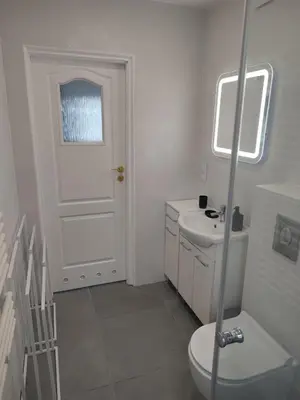 a bedroom with a bed and a table and a desk at Apartament przy 29 alei in Kraków
