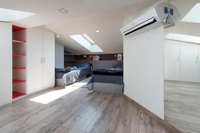 a bedroom with two beds and a ceiling with skylights at Cozy and Large 62 m2 Apartment with Air Conditioning, Old Town in Kraków