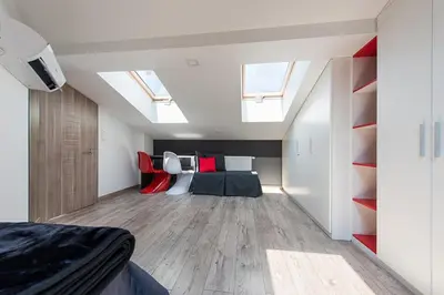 a bedroom with a bed and skylights in a attic at Cozy and Large 62 m2 Apartment with Air Conditioning, Old Town in Kraków